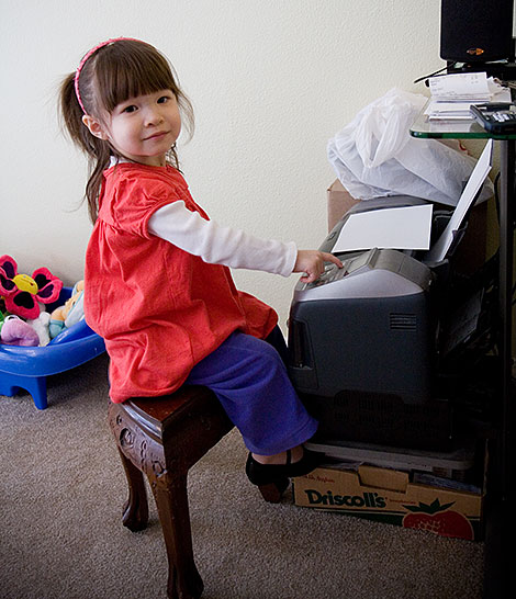 Kadie pretending to e-mail daddy with the printer - Photo by Jenni